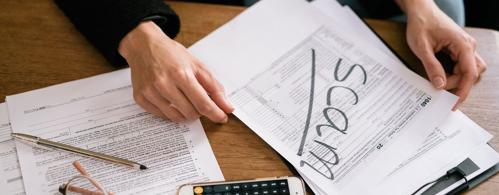 A Medicare On Main advisor reviewing income and Medicare premium paperwork with a retired couple in Grand Junction, Colorado